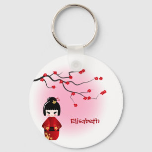 Japanische Kokeshi-Puppe beim Namen der Sakurenblü Schlüsselanhänger