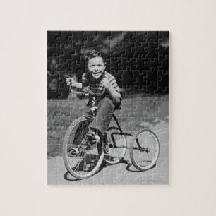 Junge fährt Dreirad Puzzle