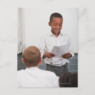 Junge stehend vor der Klasse Lesen in 2 Postkarte