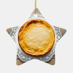 Käsekuchen auf rustikaler Holztorte oben. Keramikornament