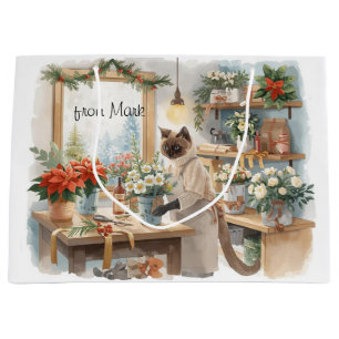 Katze arrangiert Winterblumen für Weihnachten Große Geschenktüte