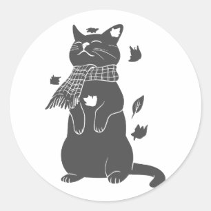 Katze in Schal bereitet sich auf den Winter vor. Runder Aufkleber