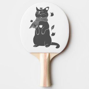 Katze in Schal bereitet sich auf den Winter vor. Tischtennis Schläger