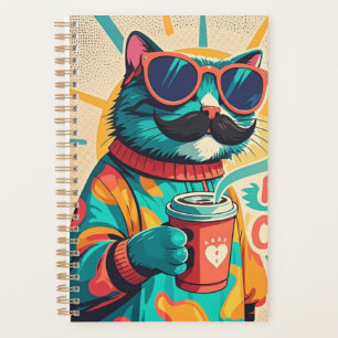Katze mit überdimensionaler Sonnenbrille und einem Planer