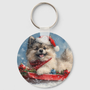 Keeshond-Hund im Schlitten Lass es schneien Weihna Schlüsselanhänger