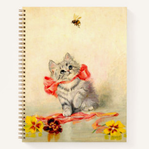 Kitten mit einem roten Band Notizbuch