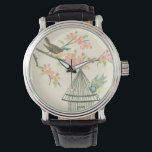 Kleine Vögel, die auf einem Zweig und auf einem Vo Armbanduhr<br><div class="desc">Nancy Slocum's haben im Laufe der Jahre viele Vögel gemalt. Dieses Bild zeigt zwei kleine blaue und gelbe Vögel auf einem Ast, umgeben von rosa Blume und sieht neugierig auf einen Vogelkäfig aus. Holen Sie sich dieses coole Stück zum Vogelgezwitscher auf Ihr Zazzle-Produkt.</div>