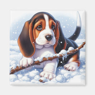 Kleine Welpe im Basset, die im Winter schneesicher Magnet