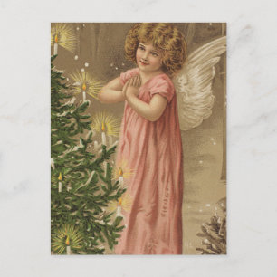 Kleiner rosa gekleideter Engel am Weihnachtsbaum Feiertagspostkarte