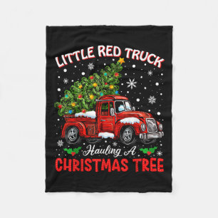 Kleiner roter LKW transportiert einen Weihnachtsba Fleecedecke