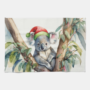 Koala-Weihnachtsmannmütze sitzt in einem Gummibaum Geschirrtuch