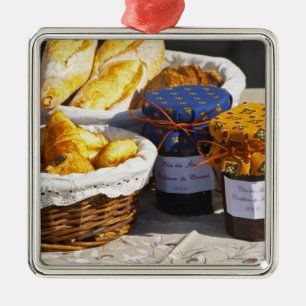 Korb mit Croissants und Schokoladenbroten. Ornament Aus Metall