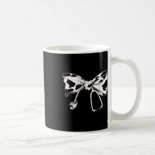 Kuhdruckbügel und Stethoskop-Abschluss Kaffeetasse