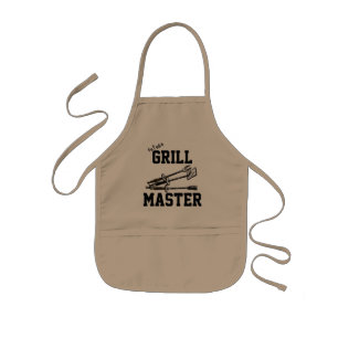 Künftiger Grill-Master mit Grill-Tools Kinderschürze