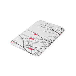 Künstlerische helle rote Vögel auf Baumasten Badematte