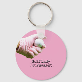 Lady Golfer hält Golfball auf pinklem Hintergrund Schlüsselanhänger