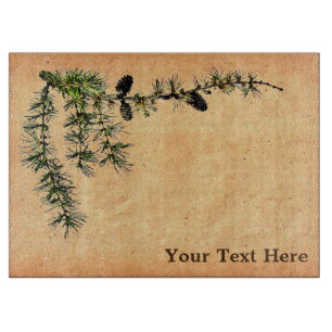 Lärchenzweig auf altem Papier Schneidebrett