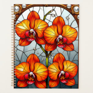 Lebendige orange Orchideen in ornamentaler goldene Planer