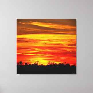 Lebendiger Sonnenuntergang über Bäumen Leinwanddruck