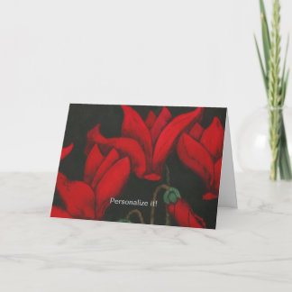 Lebhafte rote Cyclamen blühen auf dunkelschwarzem  Karte