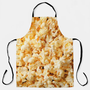 Leckeres Popcorn auf dem ganzen Hintergrund. Essen Schürze