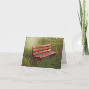 Leere Bank in Wildblumen Karte