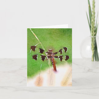 Libelle, die auf Grasanmerkungskarte stillsteht Karte