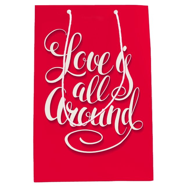 Liebe ist um die Schreibschrift pink herum Mittlere Geschenktüte (Vorderseite)