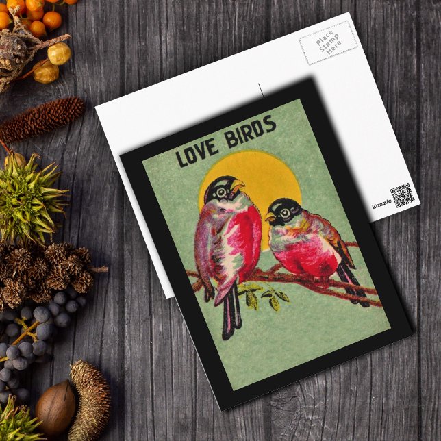 Liebesvögel Postkarte (Two pretty Love Birds dark pink on branch in front of orange sun on green postcard with black border)