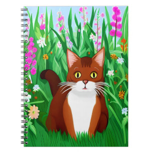 Little Ginger Brown Kitty in einem Feld der Blume Notizblock