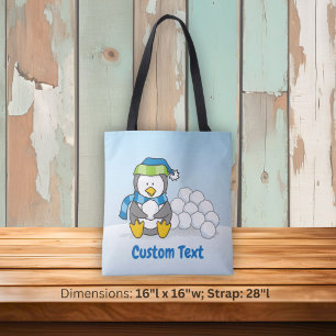 Little penguin sitting with snowballs tote bag