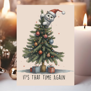 Lustige Katze klettert am Weihnachtsbaum Feiertagskarte