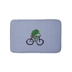 Lustiger grüner Frosch, der Fahrrad fährt Badematte