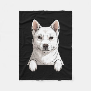 Lustiger weißer Koreanischer Jindo-Hund, der aus d Fleecedecke