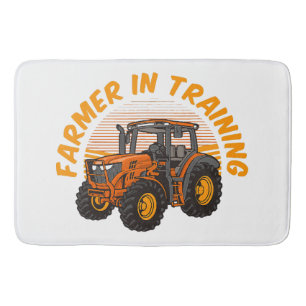 Lustiger zukünftiger Bauer in Ausbildung Traktor L Badematte