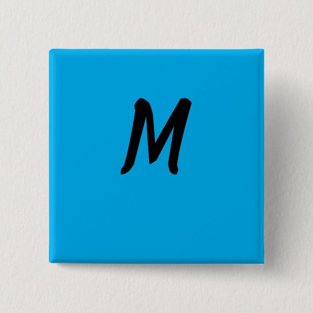 M auf einer blauen button (Vorderseite)