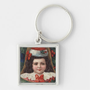 Mädchen in der Weihnachtsmannmütze in Bell Schlüsselanhänger