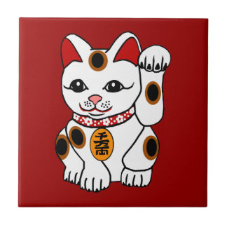 Maneki Neko Katze auf rotem Hintergrund Fliese