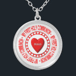 Meine erste heilige Kommunion Necklace Versilberte Kette<br><div class="desc">Diese Halskette enthält einen Host,  der von Heizen umgeben ist und ein "3-D"-Look Herz in der Mitte mit dem Namen Jesu darauf trägt. Um all dies herum stehen die Worte "Meine erste heilige Kommunion".</div>