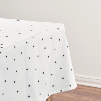 Minimalistische schwarze Punkte auf weißer Tischde Tischdecke
