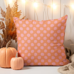 Moderne rosa Punkte auf Orange Kissen