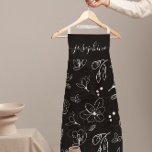 Moderne Schwarz-weiße Blumenlinie personalisiert Schürze<br><div class="desc">Mit dieser Personalisierten Schürze mit moderner Schwarz-weißer Blumenlinie stärken Sie Ihren Küchenstil. Mit einem eleganten, minimalistisch-schwarz-weißen Blumendesign bringt diese Schürze Eleganz und Eleganz in jedes Kochen- oder Backerlebnis. Passen Sie Ihren Namen an und machen Sie es zum personalisierten Geschenk für Bäcker, Koch oder alle, die Lieben in der Küche verbringen....</div>