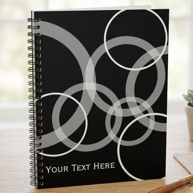 Moderne schwarze und weiße überlappende Kreise Notizblock (A modern black and white circle pattern spiral notebook for students or office workers to use daily.)
