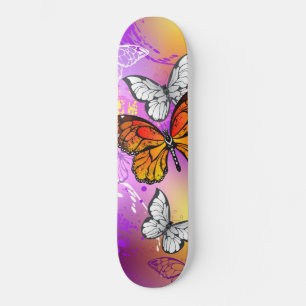 Monarch Butterflies on Purple Background Skateboard