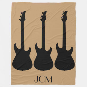 Monogram Black Electric Gitarren auf Camel Brown Fleecedecke