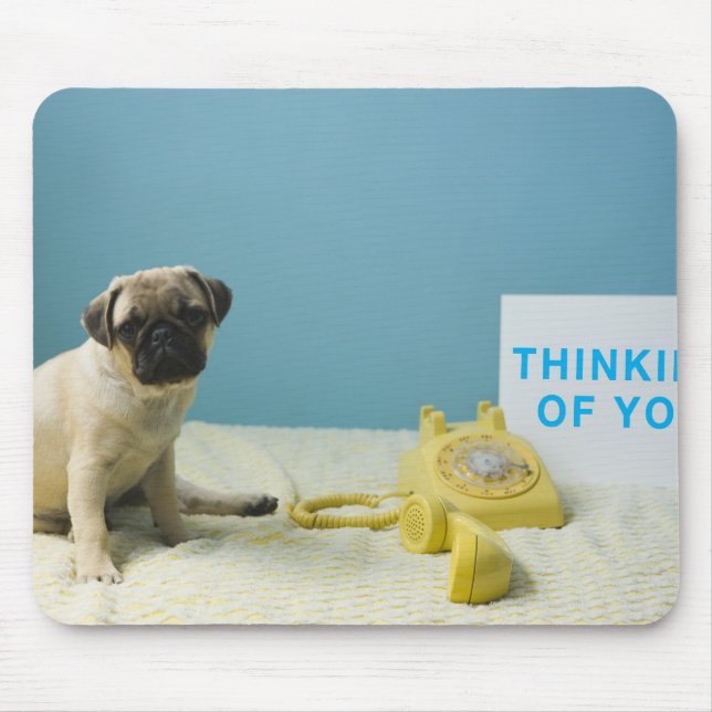 Mops Welpe sitzend auf dem Bett neben dem Telefon  Mousepad (Vorne)