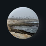 Morro Bay California Coastal Photography Button<br><div class="desc">A foggy overcast day in Morro Bay California with the ocean waves hitting the rocks on the shore in this beach photograph souvenir. This seaside travel photo keepsake button features black cursive script above the beach rocks and grey sky.</div>