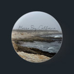 Morro Bay California Coastal Photography Button<br><div class="desc">A foggy overcast day in Morro Bay California with the ocean waves hitting the rocks on the shore in this beach photograph souvenir. This seaside travel photo keepsake button features black cursive script above the beach rocks and grey sky.</div>