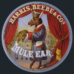Mule Oar Tobacco Label<br><div class="desc">Tabaketikett, auf dem ein auf den Hinterbeinen stehendes Maultier in voller Länge dargestellt wird, das Kleid und die Brille trägt und Tabak-Blätter trägt. Harris, Beebe & Cos., erstellt von The Hatch Lithography Co., 1868</div>