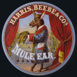 Mule Oar Tobacco Label Button<br><div class="desc">Tabaketikett,  auf dem ein auf den Hinterbeinen stehendes Maultier in voller Länge dargestellt wird,  das Kleid und die Brille trägt und Tabak-Blätter trägt. Harris,  Beebe & Cos.,  erstellt von The Hatch Lithography Co.,  1868</div>